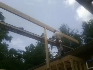 Carpenter setting a ridge beam over a new addition frame — Ice Dam Removal by Roofing Brothers in Dodgeville