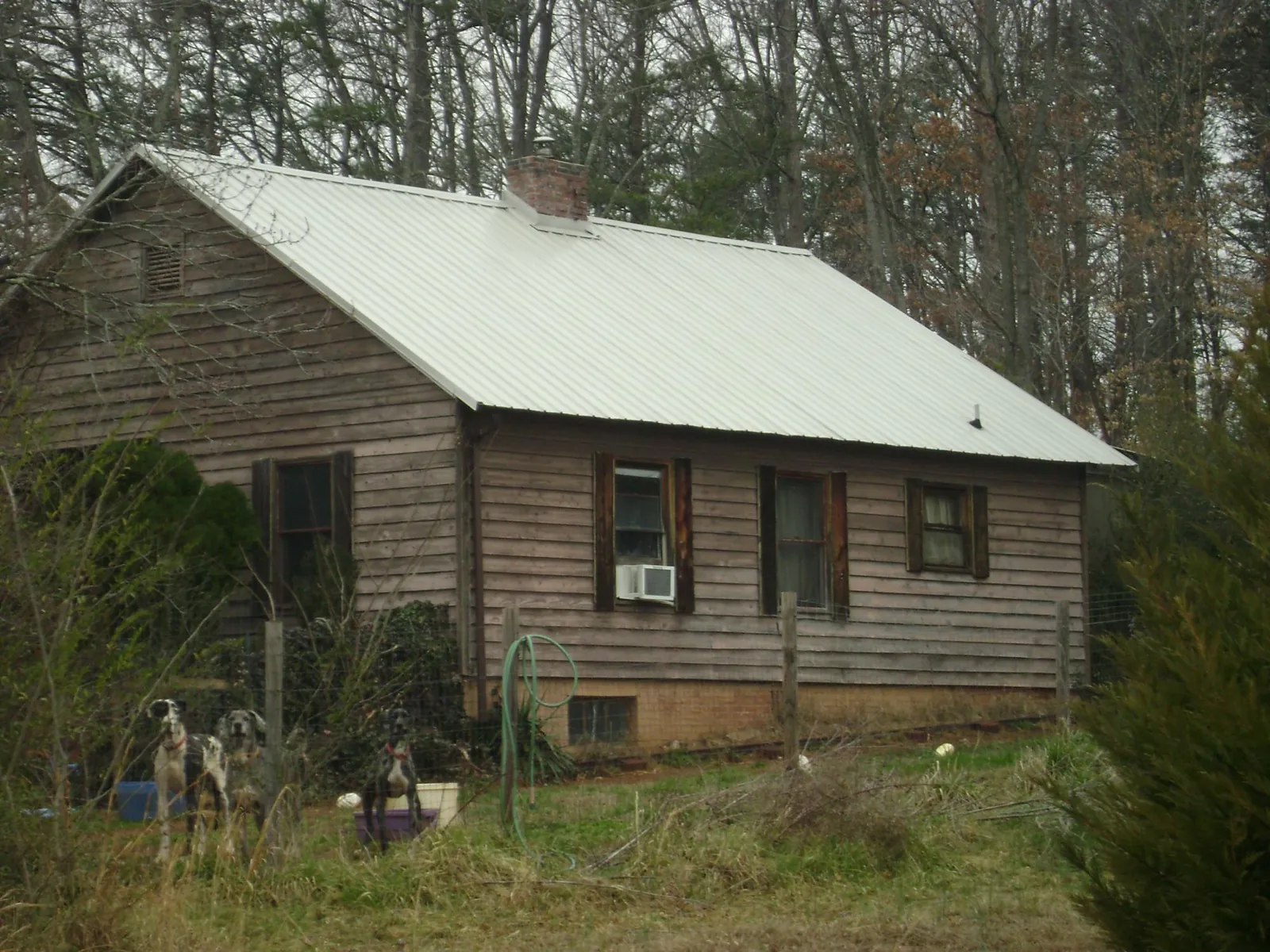 White metal roof on an old wood sided farmhouse, from a Metal Roof Installation job in Dodgeville